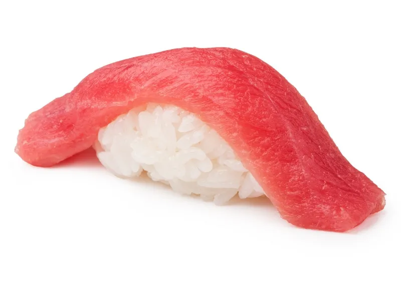 Tuna nigiri sushi on plain white background at Sucré d’Amour Café & Sushi, a Sushi Restaurant in Fremont